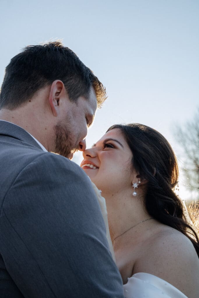 Bride and groom nose to nose and smiling
